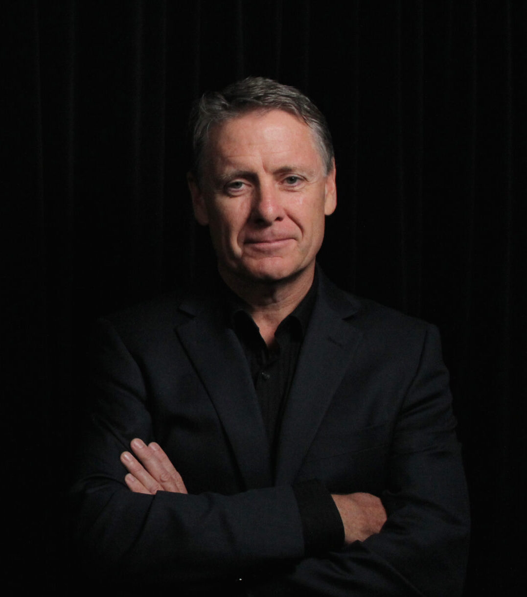 Tony Hughes black background wide friendly offset right